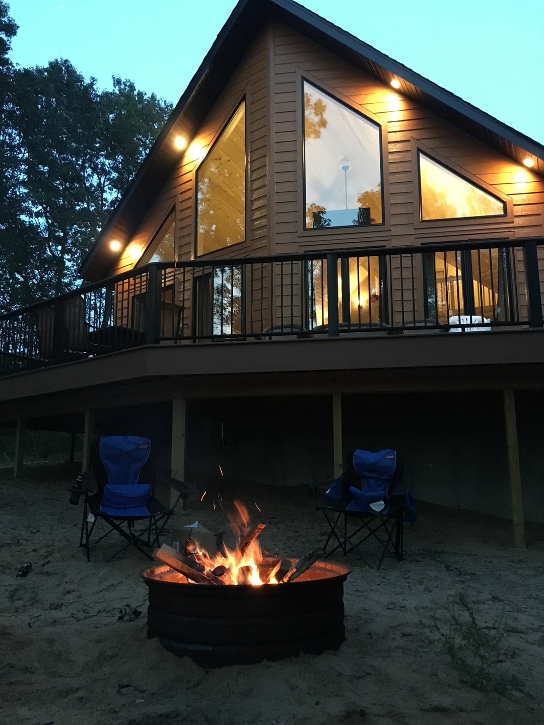 Cabin exterior with outdoor lighting at dusk